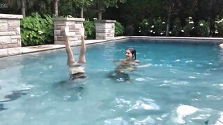 Two Bikini Teens challenging each other in pool