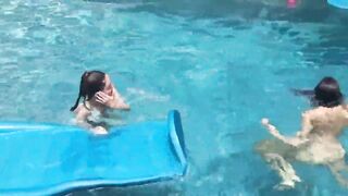 Two Bikini Teens challenging each other in pool