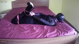 Laura on Heels hogtied on the bed in stockings and high heels