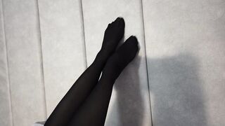 Stretching Sexy Legs and Feet in Black Pantyhose Lying on the Bed