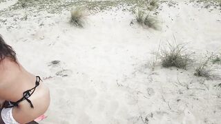 Leashed girl sucking on the beach