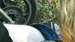 Biker's girlfriend gives him a blowjob outdoors