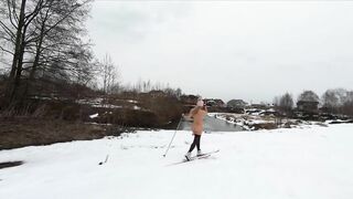 Naked girl skiing in the countryside