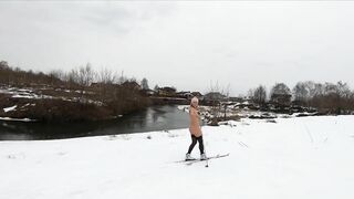 Naked girl skiing in the countryside