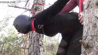 Tied up to a tree outdoor on sexy clothes, wearing pantyhose and high ankle boots heels, rough fuck