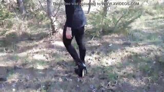 Walking on the wood wearing a black dress, pantyhose and high heels ankle boots