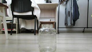 MILF peeing profusely in a jar