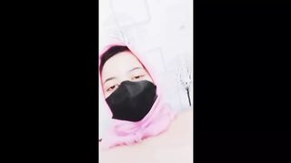 hijab woman playing with dildo in room